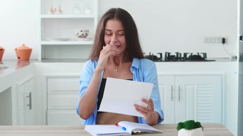 Woman Receives Good News in the Kitchen