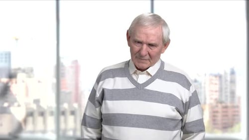Senior Stressed Man Suffering From Headache