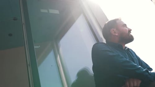 Man Standing in Sunlight Gazing Upward