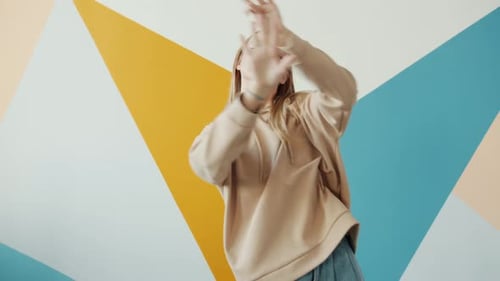 Slow Motion Portrait of Young Girl Teenager Dancing in Studio Looking at Camera Smiling