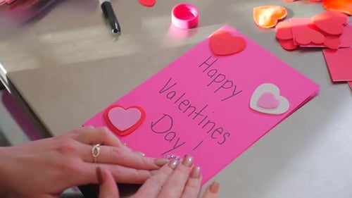 Woman's Hands Making Valentine's Day Card