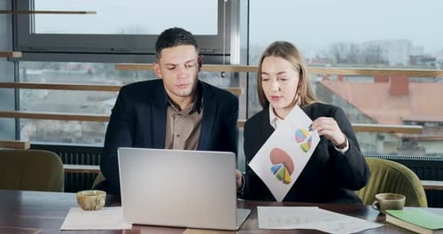 Man and a Woman Discussing Work in the Brightly Lit Modern Office, Concerned Male and Female Working