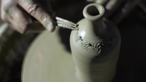 Potter Drawing on a Vase