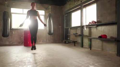 Sporty woman exercising building muscles at the gym