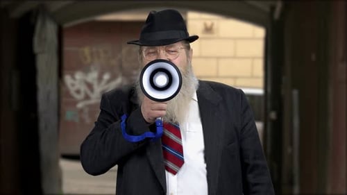 Man With Beard Speaks Into Megaphone Outside