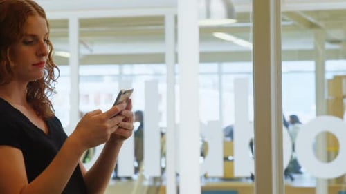Businesswoman using mobile phone in office