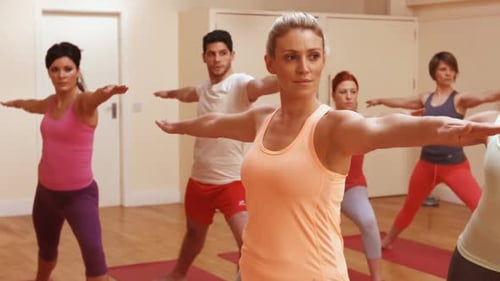 Adults Practice Yoga in Fitness Studio