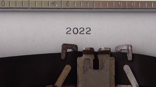 Typing 2022 on retro typewriter. Close up.