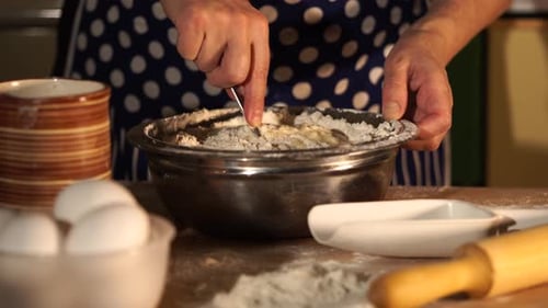 Close Up Shot of Housewife's Hands Who Mixes the Flour with Water Eggs for Dough