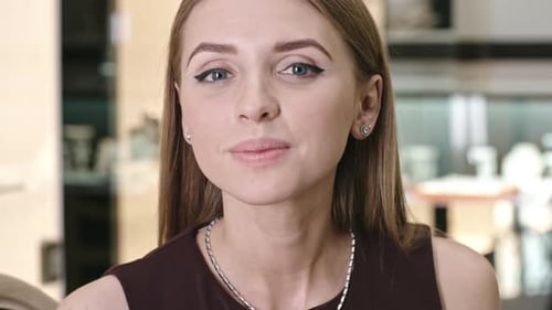 Woman Trying On Earrings in Store