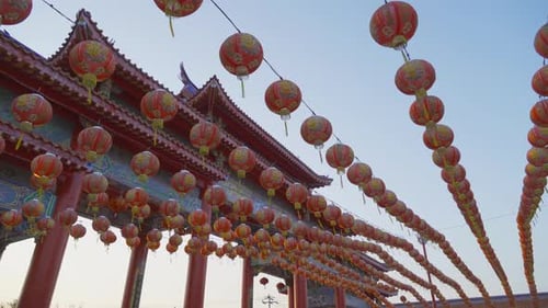 Red chinese lanterns hanging on wire outdoor lamps in temple of China Town decoration