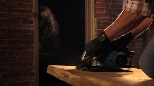 Close Up Shot of a Man's Hands Who Works with a Carpentry Tool in His Workshop