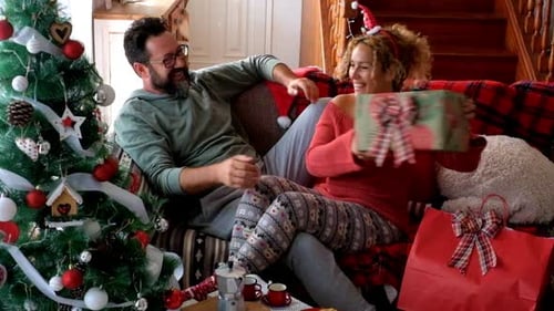 Loving Couple Exchange Gifts at Christmas Time