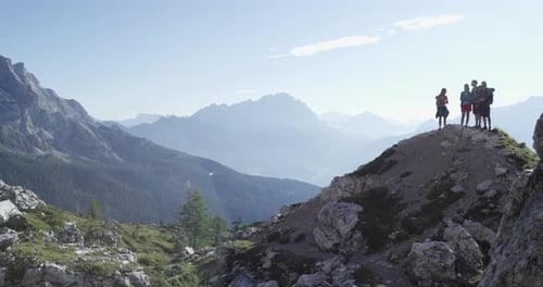 Four Friends Looking Panorama on Peak Top Hiking Trail Path