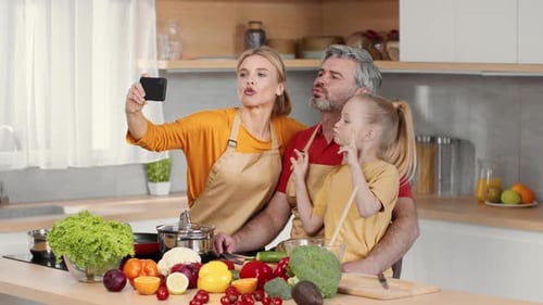Playful Family Takes Selfie in Bright Kitchen