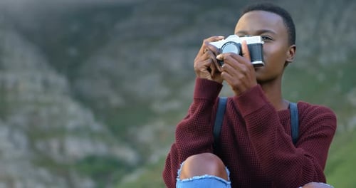 Young Adult with Camera Smiling Outdoors