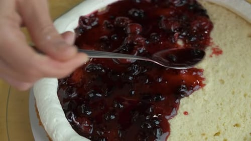 Close Up of Woman Hands Making Sweet Cherry Cake with White Cream and Biscuit