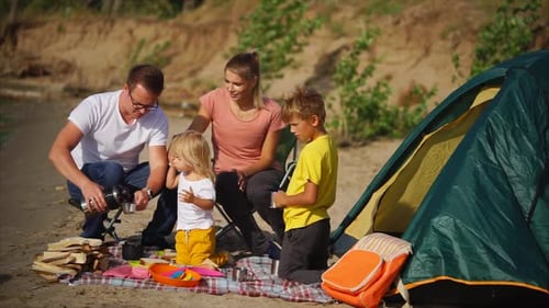 Family camping at the beach near the lake