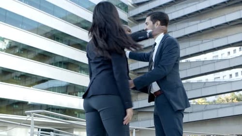 Business People Greeting Each Other Near Office Building