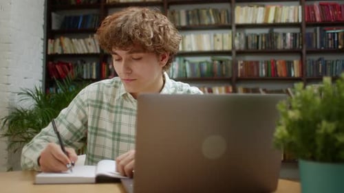 Young Student Man Study With Online Lesson in the Home Office or Library Talk Conference Calling Do