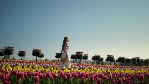 Young Woman Relaxing in Summer Flower Garden