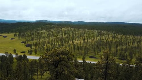Epic Aerial Drone Shot of Large Tree Covered Rocky Hills Revealing Incredible National Park Forest