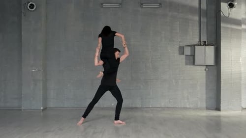 Dancers Performing Acrobatic Dance Routine in Studio