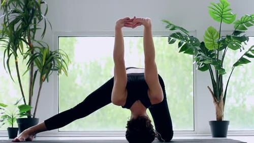 Athletic Woman Performing Advanced Yoga Pose at Home