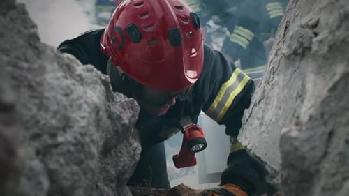 Firefighter Crawling Through Rubble After Disaster