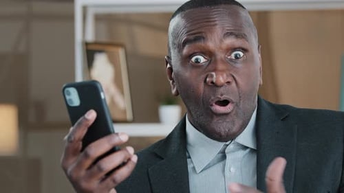 Man Shocked by Content on Mobile Device