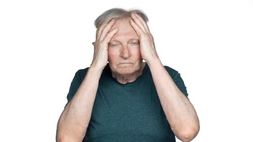 Senior Man Rubbing Temples Due to Headache