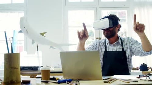 Man Uses Virtual Reality Headset at His Desk