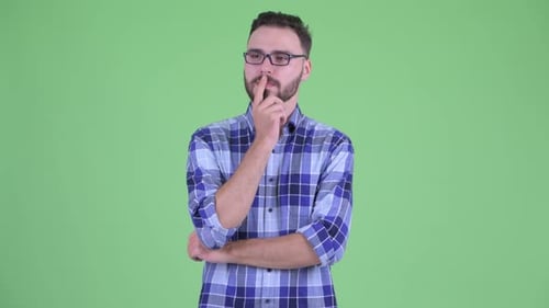 Bearded Man Smiles While Holding Chin