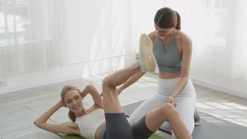 Women Working Out with Trainer in Bright Home