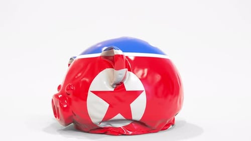 Deflating Inflatable Piggy Bank with Flag of North Korea