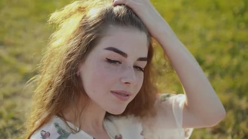 Young Woman Smiling in Sunny Outdoor Close-up