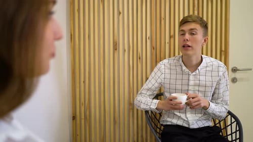 Man and Woman Talking in an Office Environment