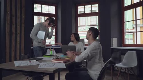 Young Adults Collaborating at Conference Table