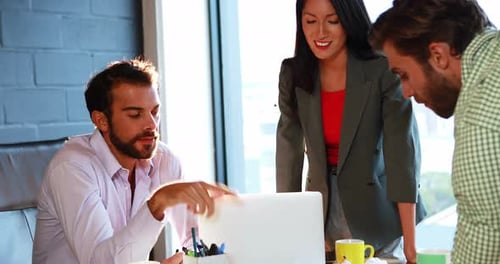 Team Working Together at the Office on a Laptop
