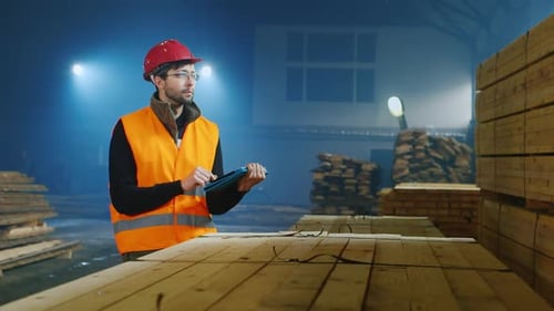 The Ingineer Works in a Warehouse Uses a Tablet