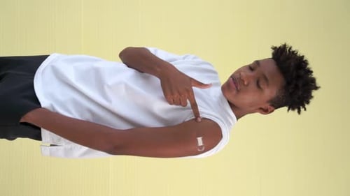 Teen Points to Bandage After Vaccination