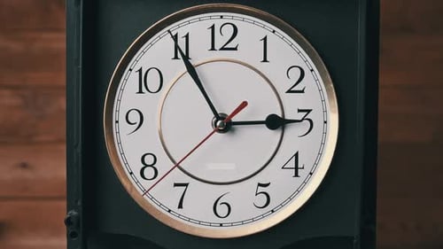 Vintage Wall Clock with Moving Second Hand on Wooden Background