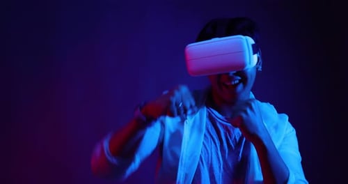 Young Asian man playing metaverse virtual reality digital technology game.