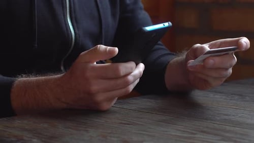 Person Using Smartphone and Credit Card