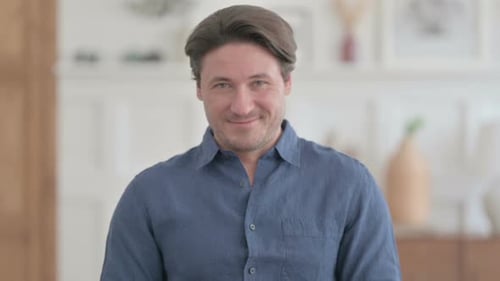 Man Smiling Genially Indoors in Close Up Portrait