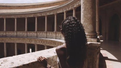 Woman Exploring Historic Architecture Takes Pictures