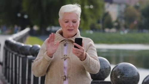 Senior Woman Talking on Smartphone Outdoors
