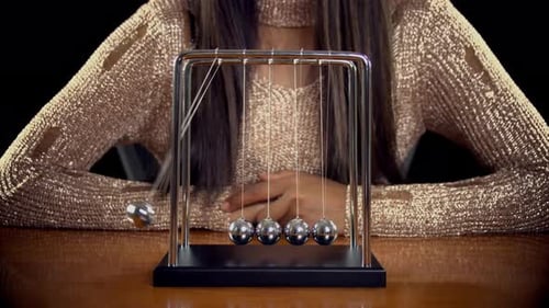 Newton's Cradle Swinging Back and Forth