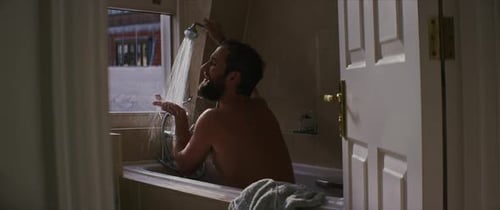 Young man enjoying hot shower