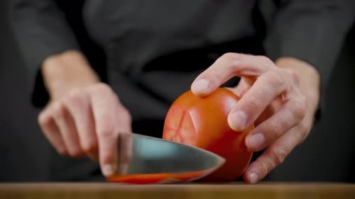 Close Up of a Tomato Being Sliced